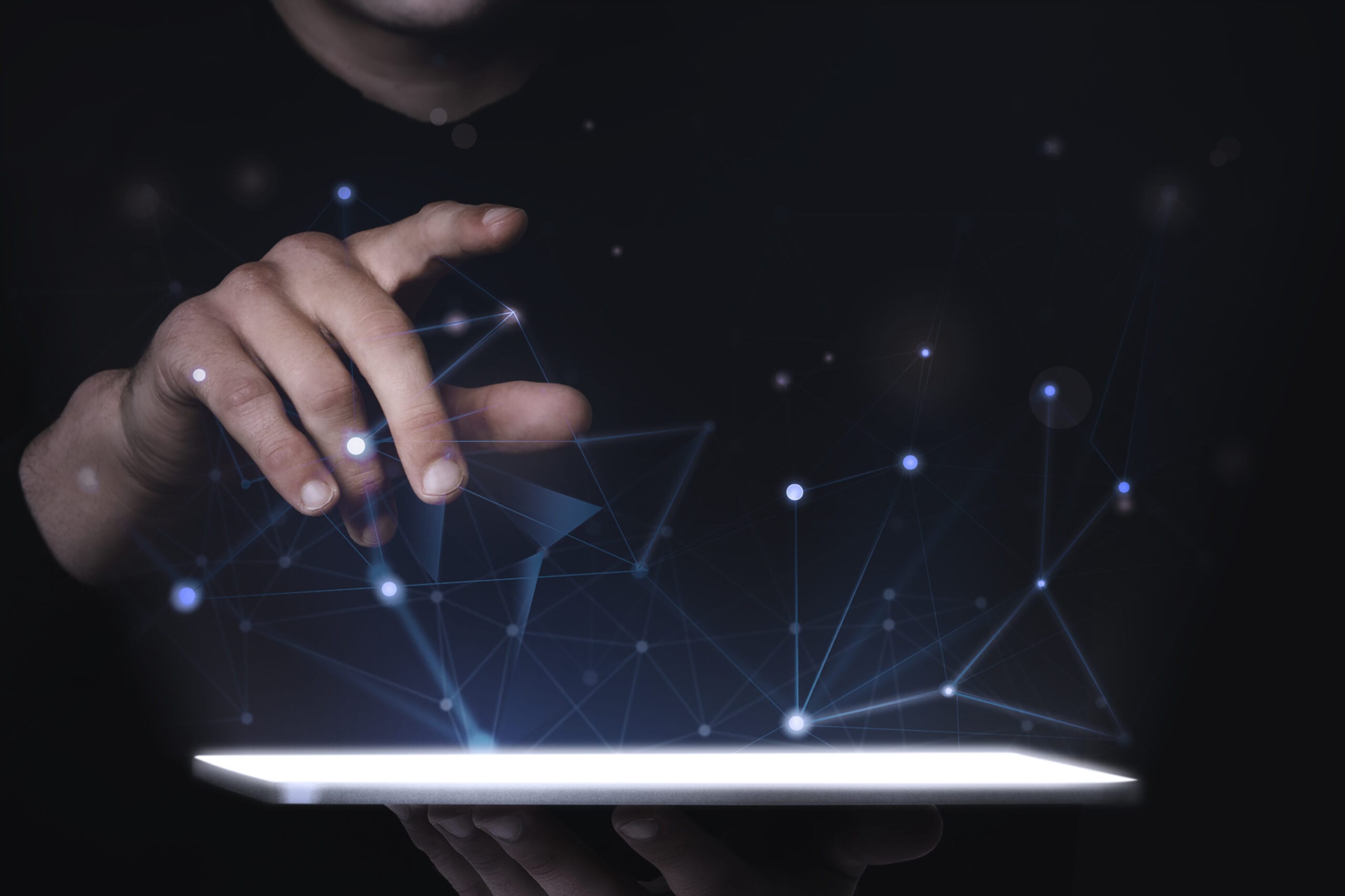 Hand interacting with a digital network on a bright tablet screen, symbolizing data analytics transforming operations.